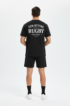Full body back view of male model wearing black Ten Attire Rugby tee