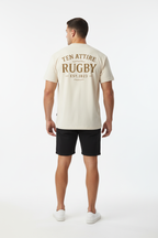 Full body back view of male model wearing cream Ten Attire Rugby tee
