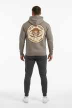 Full body back view of male model wearing grey Ten Attire Rugby skull badge hoodie