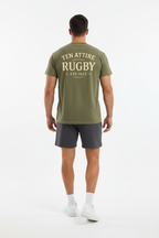Full body back view of male model wearing olive green Ten Attire Rugby tee