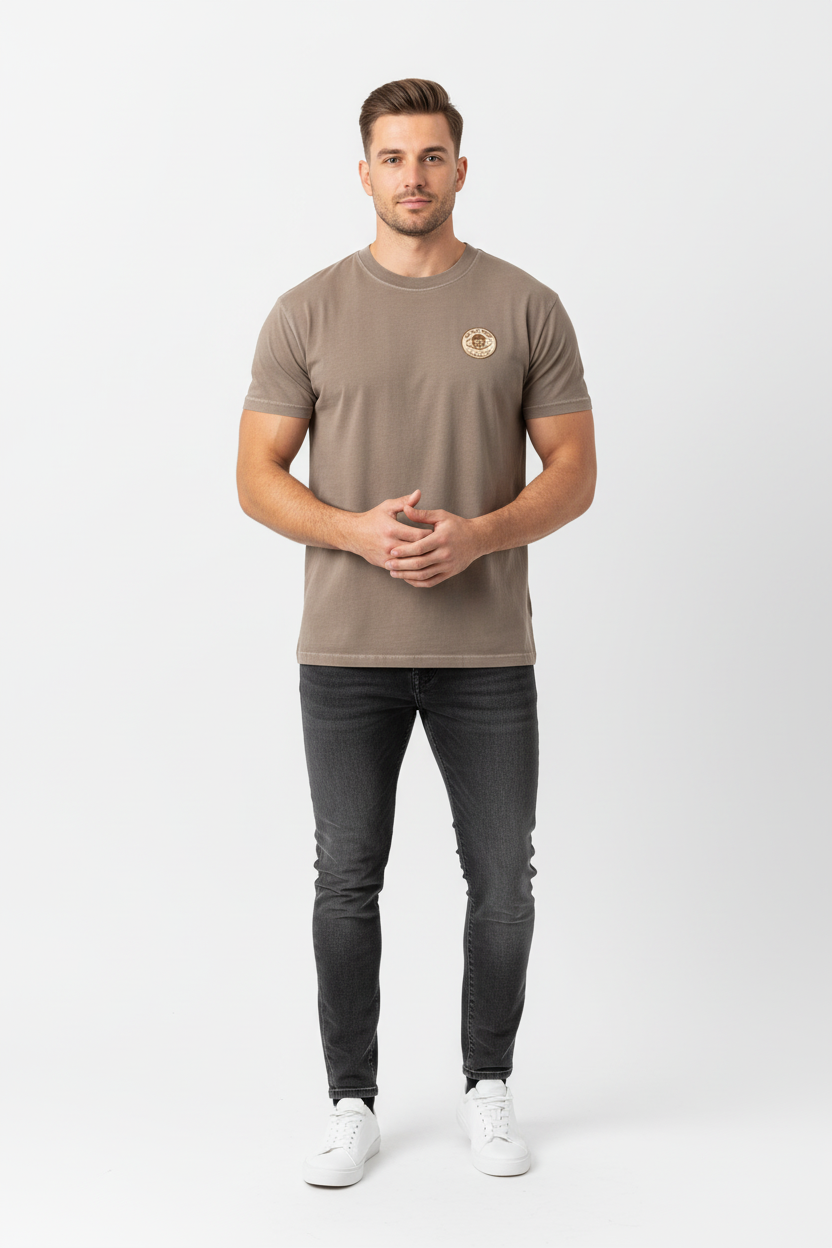 Full body front view of male model wearing brown Ten Attire Rugby skull badge tee
